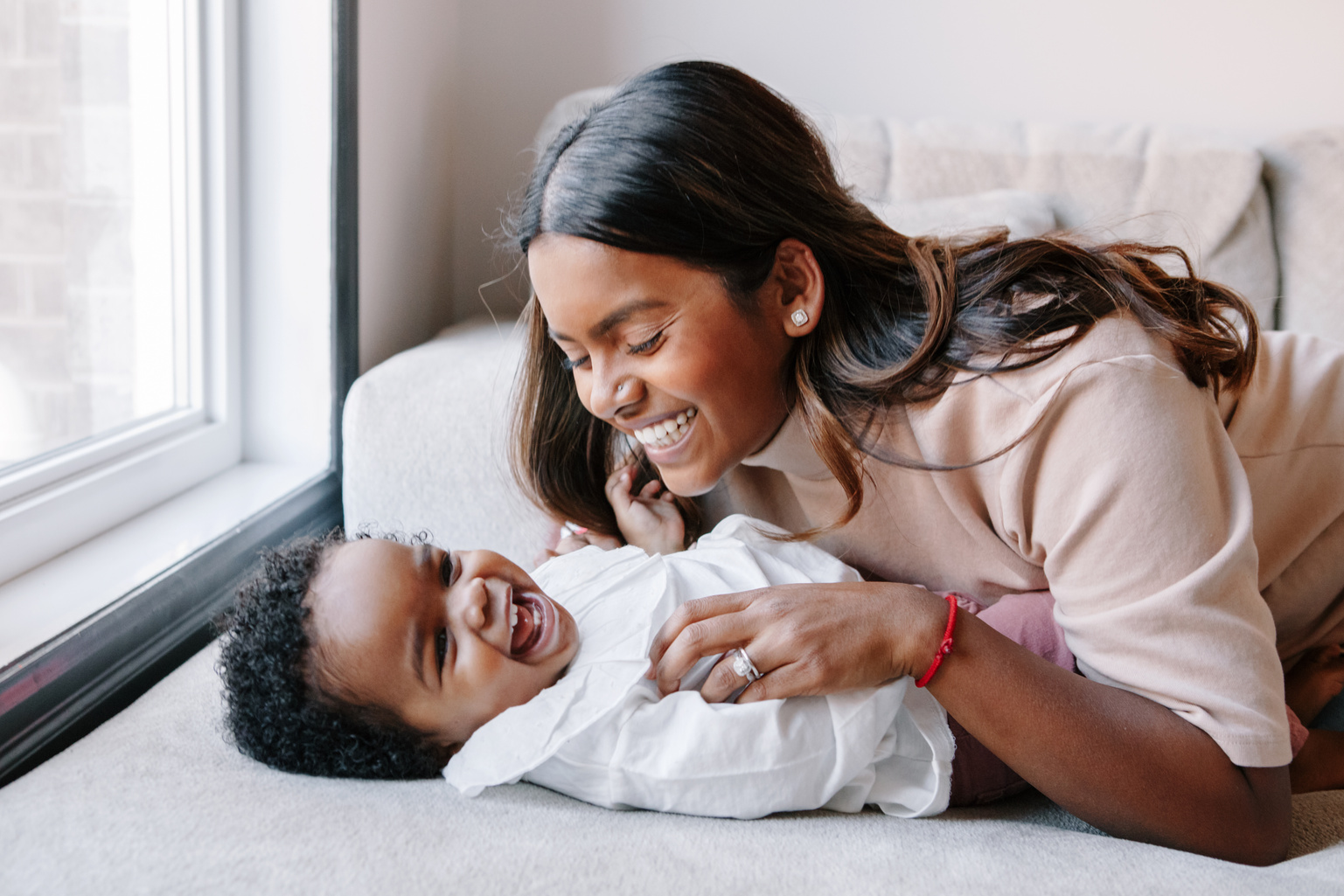 Happy Smiling Laughing Indian Mother Playing with Black Baby Gir